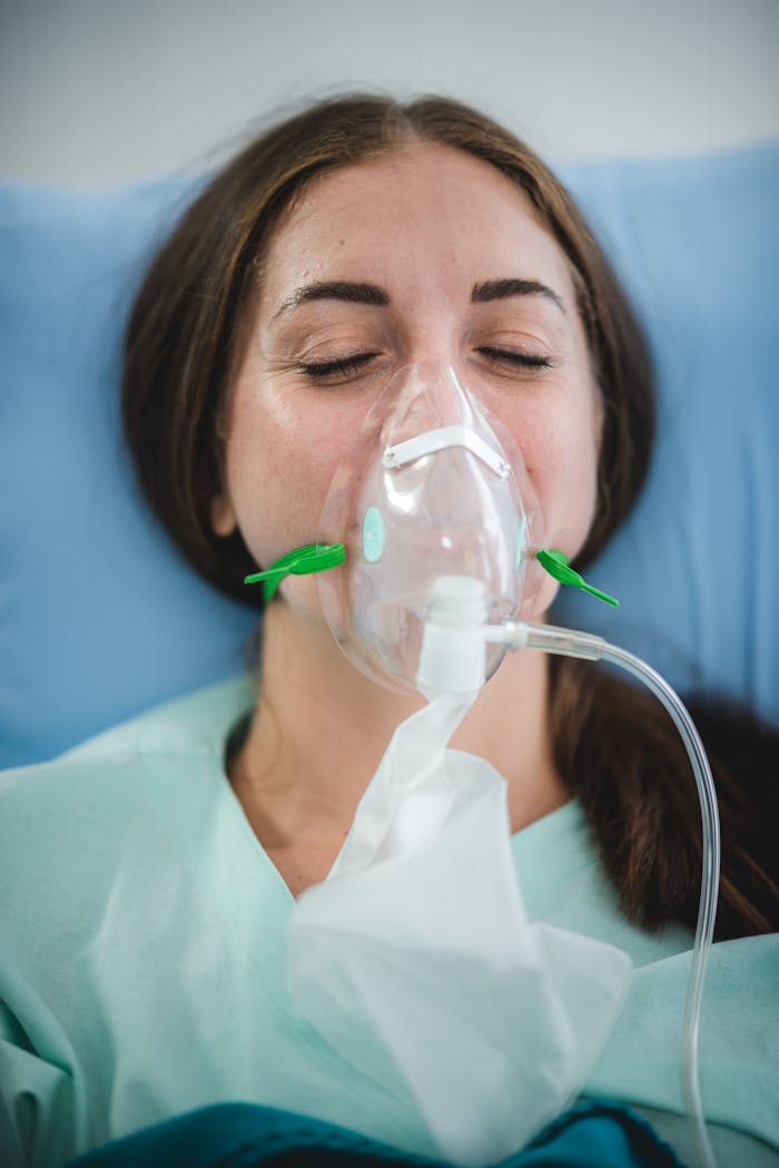 about-01 Caucasian woman in hospital bed wearing oxygen mask for medical treatment and recovery.