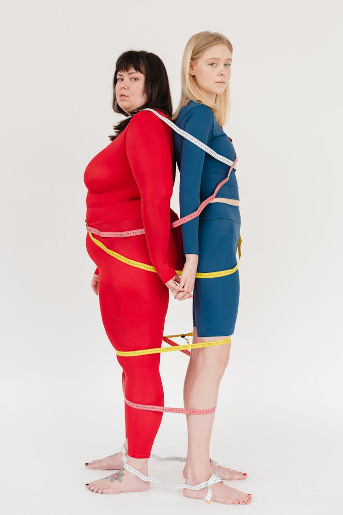 services-cta Women in colorful activewear with measuring tapes, celebrating body positivity.